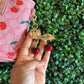 A BOLSA COACH ROSA CON LLAVERO CEREZAS