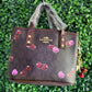 A BOLSA COACH CAFE LLAVERO CEREZAS CAFE