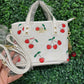 A BOLSA COACH CON LLAVERO DE CEREZA