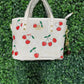 A BOLSA COACH CON LLAVERO DE CEREZA