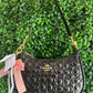 A BOLSA NOLITA COACH NEGRA CON LLAVERO DE PERLAS