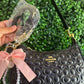 A BOLSA NOLITA COACH NEGRA CON LLAVERO DE PERLAS